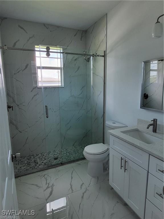 bathroom with vanity, an enclosed shower, and toilet