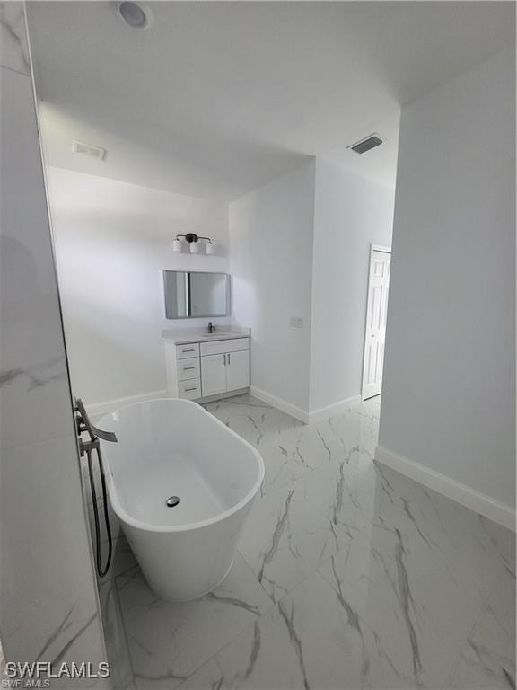 bathroom with vanity and a tub