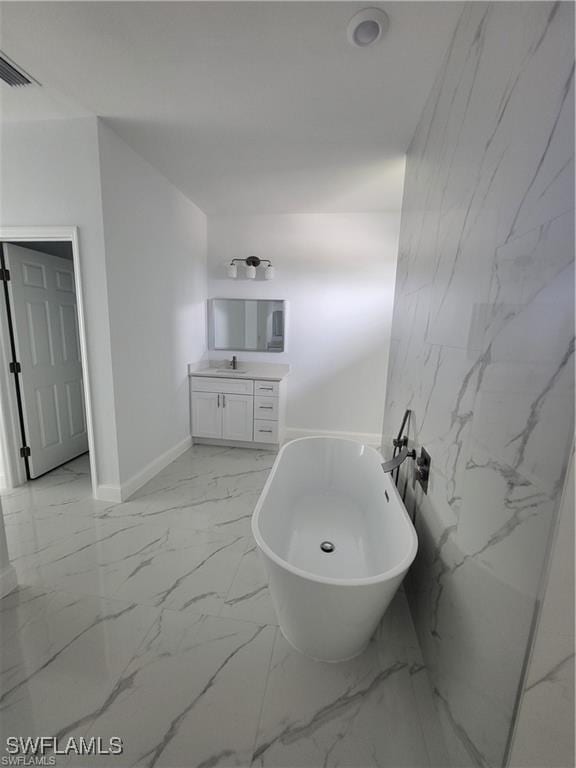 bathroom with vanity and a bathtub