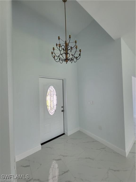 entrance foyer featuring an inviting chandelier