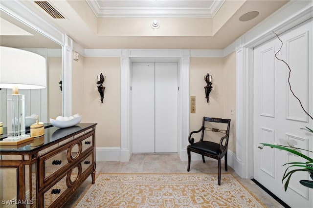 living area featuring ornamental molding, a raised ceiling, and elevator