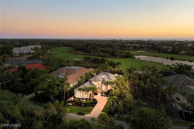 aerial view at dusk with a water view