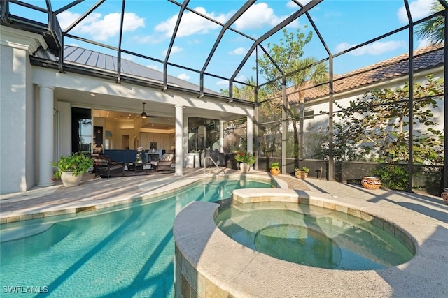 view of swimming pool featuring an in ground hot tub, outdoor lounge area, a patio area, and glass enclosure