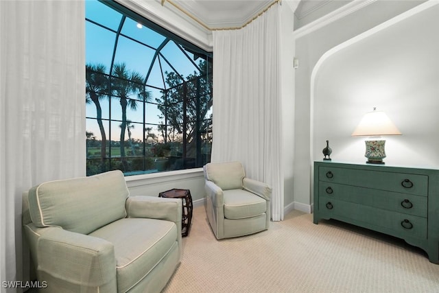 sitting room with crown molding and light colored carpet