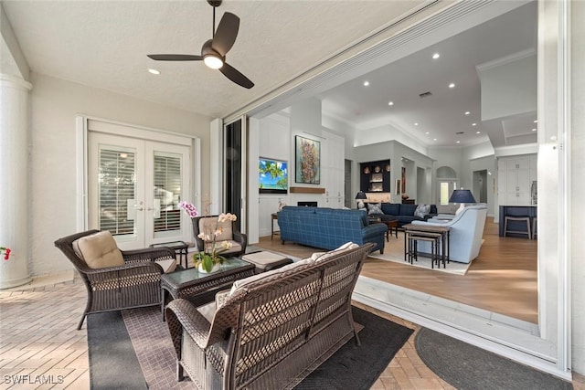 interior space with french doors, ceiling fan, outdoor lounge area, and a patio