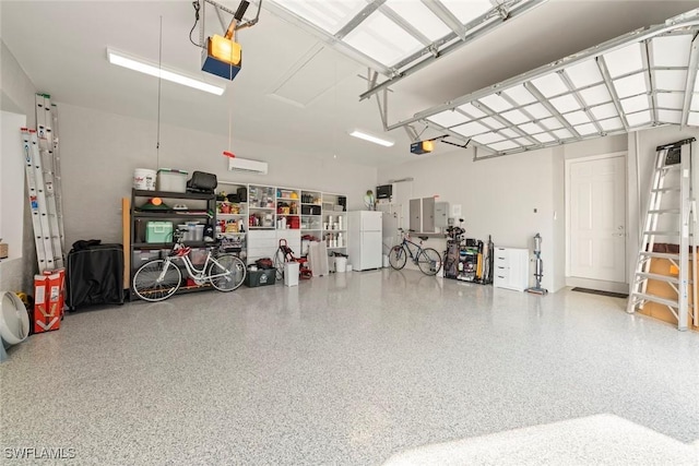 garage featuring white refrigerator, a garage door opener, and electric panel