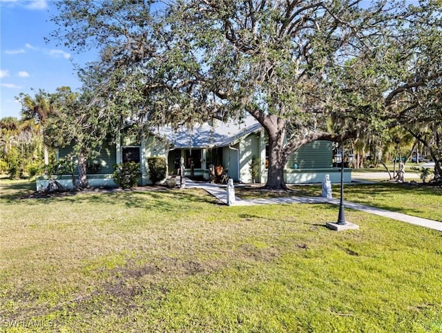 obstructed view of property featuring a front yard