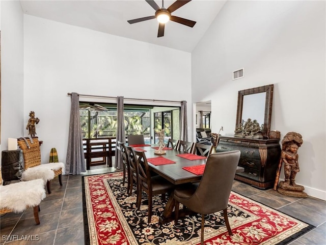 dining space with ceiling fan and high vaulted ceiling