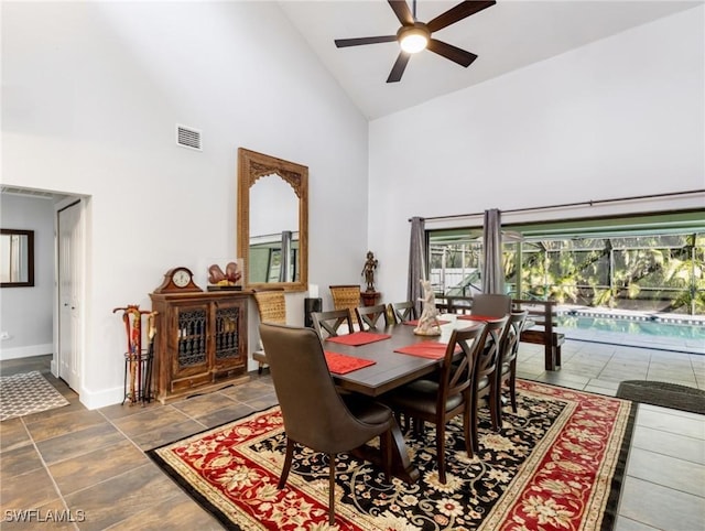 dining area featuring ceiling fan and high vaulted ceiling