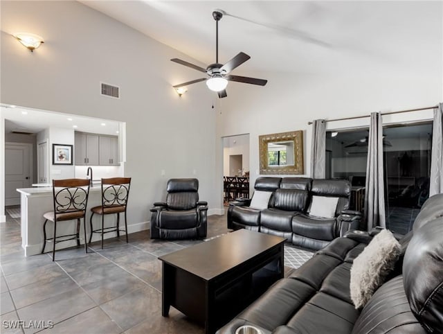 living room with high vaulted ceiling and ceiling fan