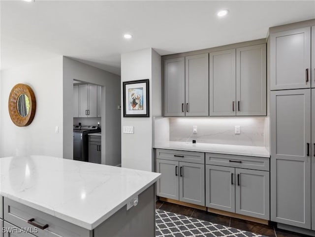 kitchen featuring independent washer and dryer and gray cabinetry