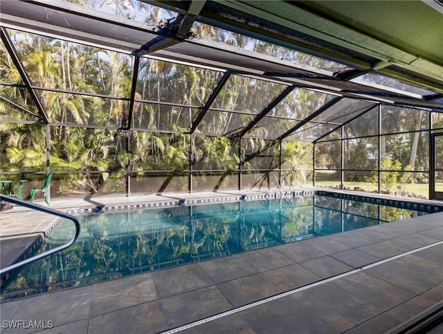 view of pool with glass enclosure