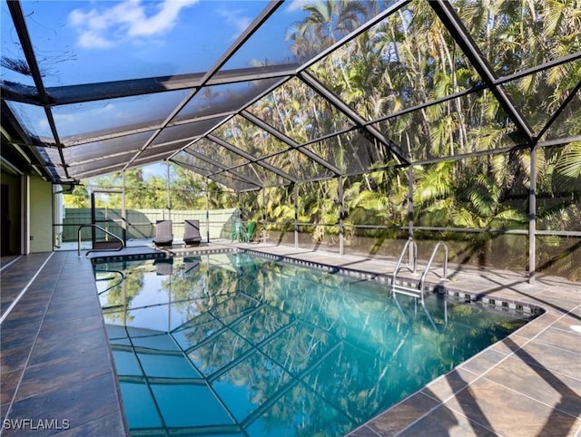 view of pool with a lanai and a patio area