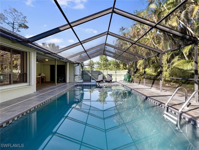 view of pool with a lanai and a patio