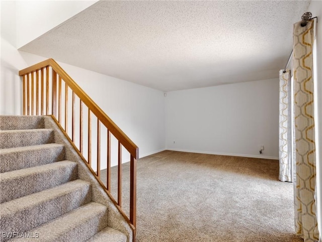 interior space with a textured ceiling and carpet