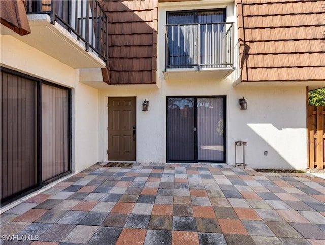 doorway to property with a patio area