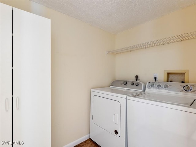 laundry area featuring washer and dryer and a textured ceiling