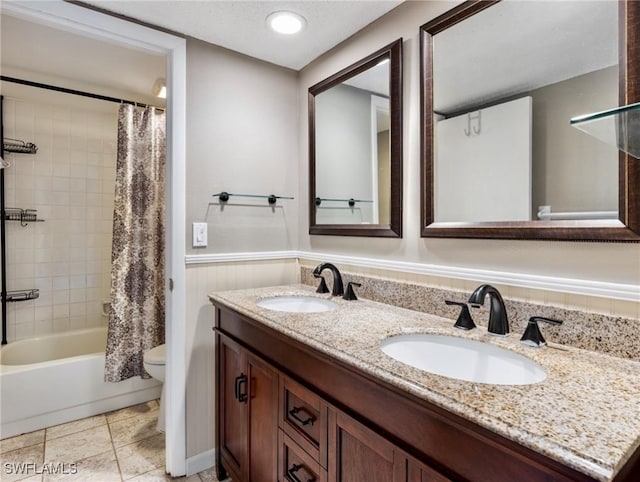 full bathroom featuring tile patterned flooring, vanity, a textured ceiling, toilet, and shower / bath combo with shower curtain