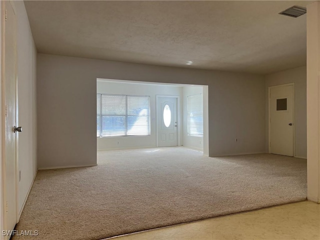 view of carpeted foyer entrance