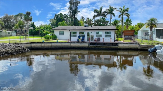 back of property with a water view