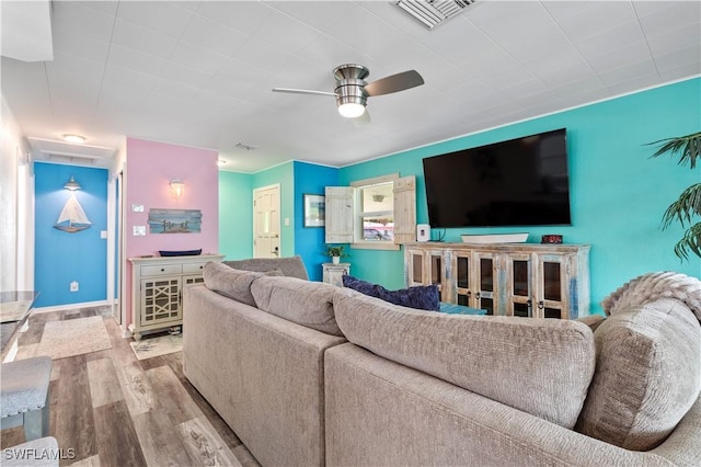 living room with ceiling fan and light hardwood / wood-style flooring