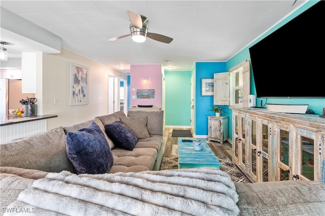 living room with hardwood / wood-style flooring and ceiling fan