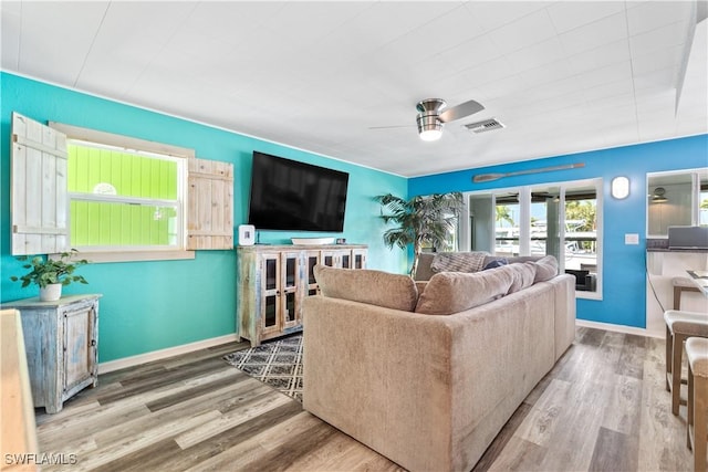 living room featuring hardwood / wood-style flooring and ceiling fan