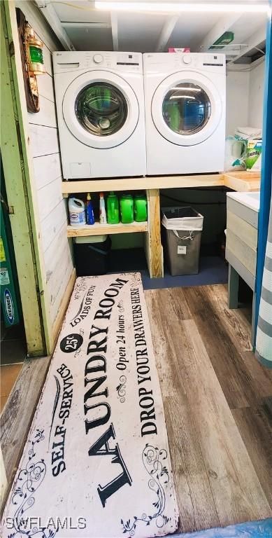 clothes washing area featuring hardwood / wood-style floors