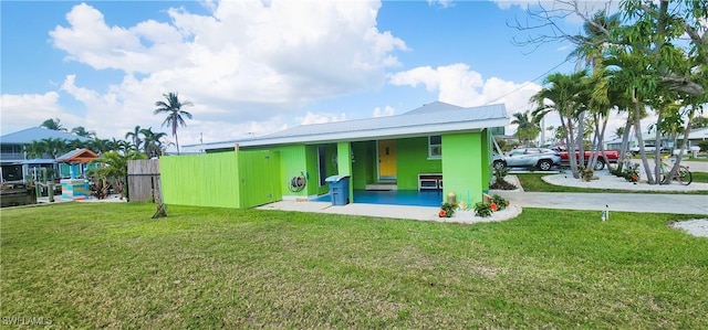 rear view of house with a yard