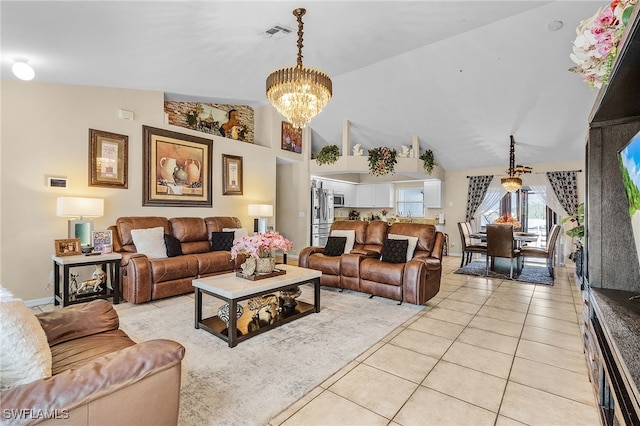 tiled living room featuring high vaulted ceiling and an inviting chandelier