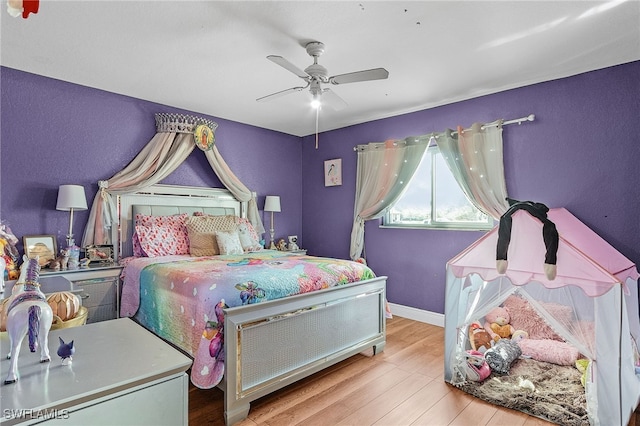 bedroom with ceiling fan and light hardwood / wood-style floors