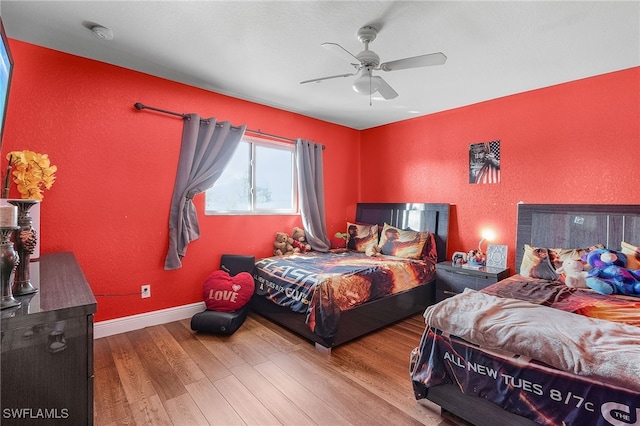 bedroom with hardwood / wood-style flooring and ceiling fan