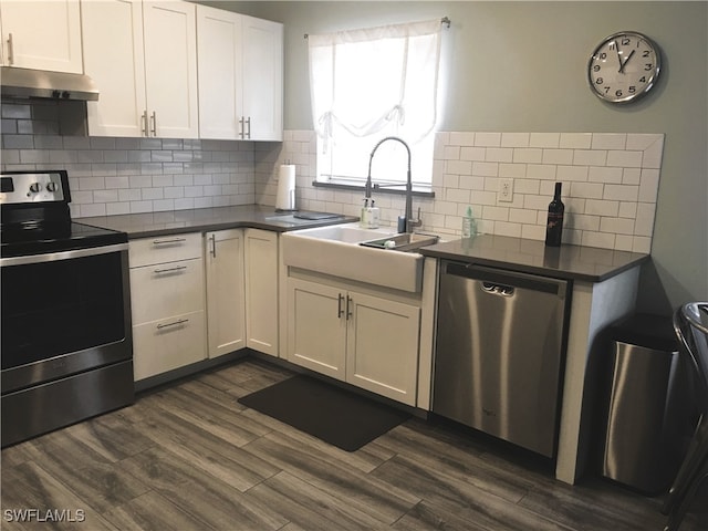 16881 Davis Rd Unit 712, Fort Myers, FL 33908 - kitchen with white cabinetry, sink, backsplash, dark hardwood / wood-style flooring, and stainless steel appliances