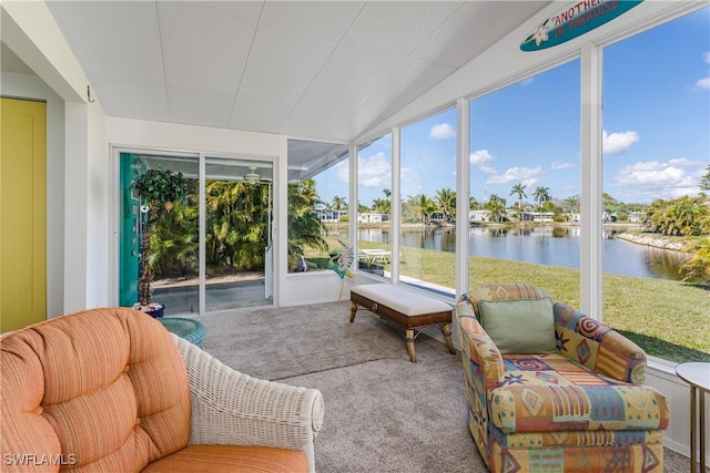 sunroom / solarium featuring a water view