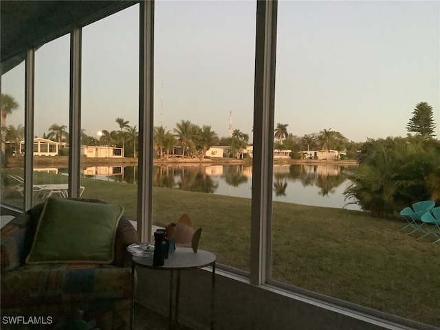 unfurnished sunroom featuring a water view