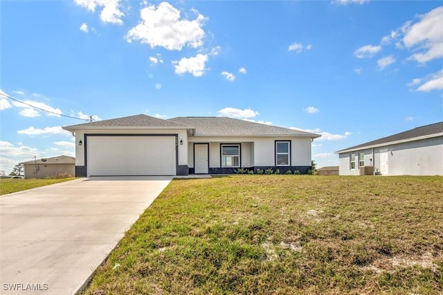 view of front of house featuring a garage and a front yard