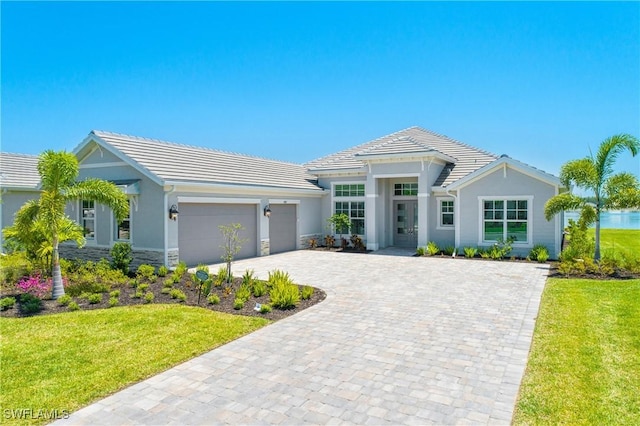 view of front of home with a garage and a front lawn