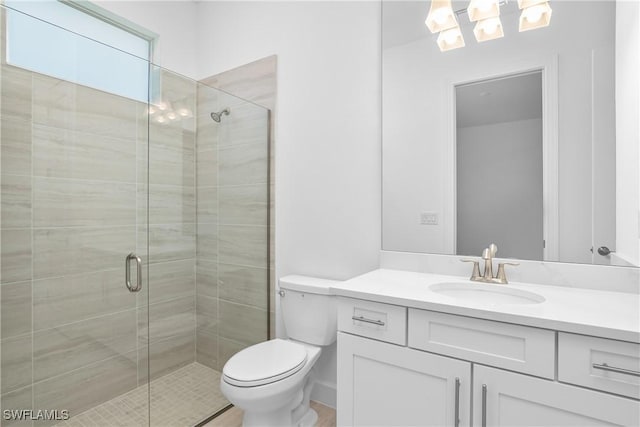 bathroom featuring an enclosed shower, vanity, and toilet