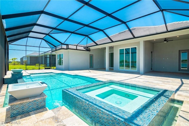 view of swimming pool with an in ground hot tub, a lanai, ceiling fan, and a patio area