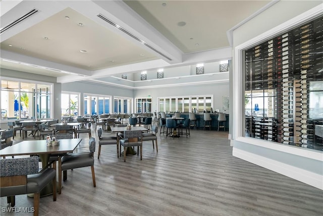 dining space with hardwood / wood-style floors and beamed ceiling