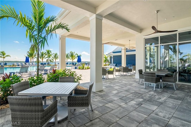 view of patio / terrace featuring ceiling fan and a water view