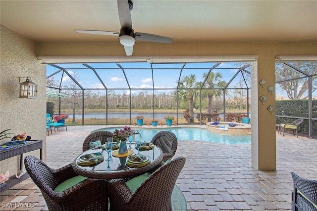 view of patio with a water view, ceiling fan, a lanai, and a pool with hot tub