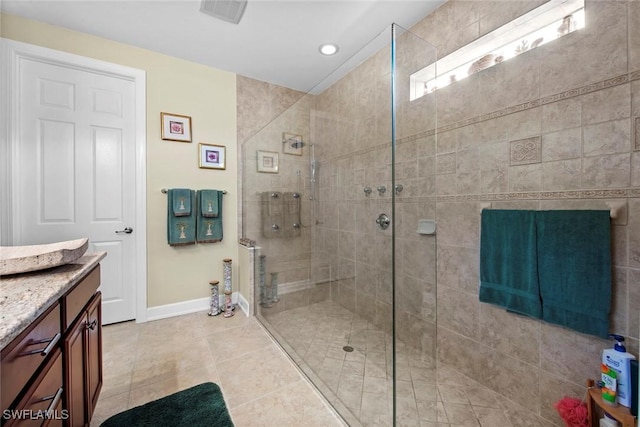 bathroom with vanity, tile patterned floors, and a shower with door