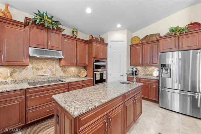 kitchen with sink, backsplash, stainless steel appliances, a center island, and light stone counters