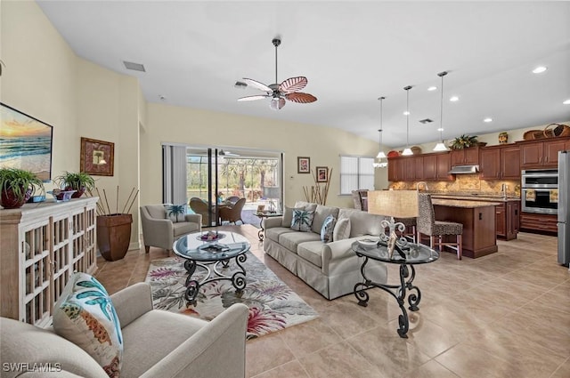 living room featuring light tile patterned floors and ceiling fan