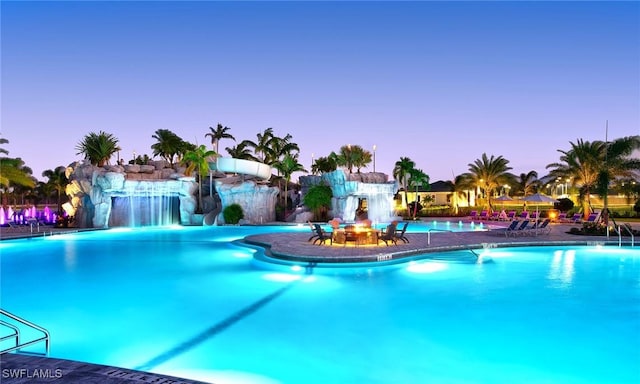 pool at dusk with pool water feature