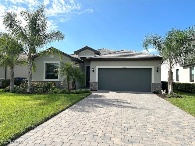 view of front of property with a garage and a front lawn