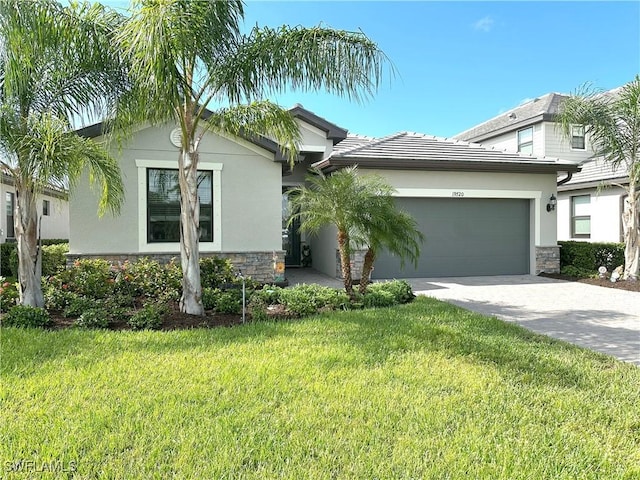 view of front of house with a garage and a front lawn