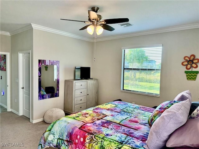 carpeted bedroom with ceiling fan and ornamental molding