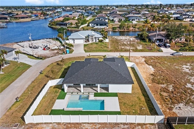 bird's eye view featuring a water view and a residential view